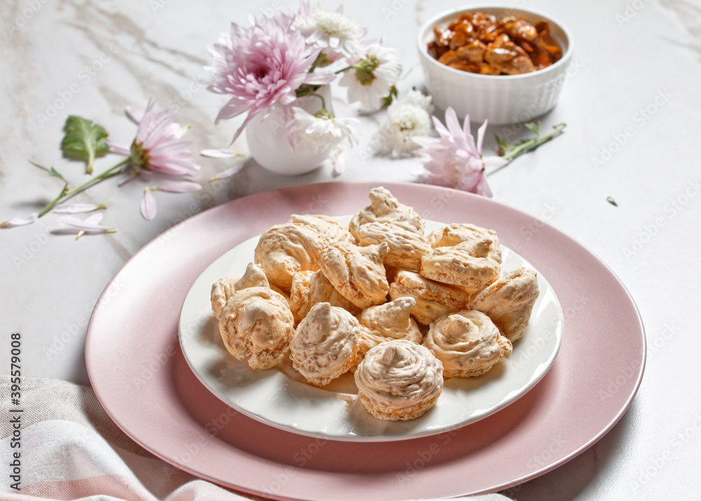 Swirled meringue cookies with caramelized walnuts of egg whites whipped with sugar Swirled meringue cookies with caramelized walnuts of egg whites whipped with sugar