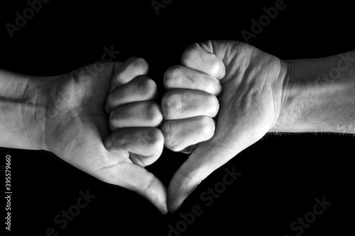 Heart with two different hands of white people celebrating love
