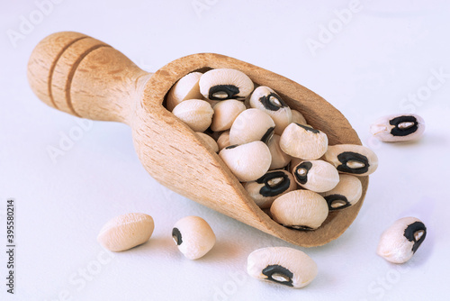 Eye beans in a wooden bailer on a white background
