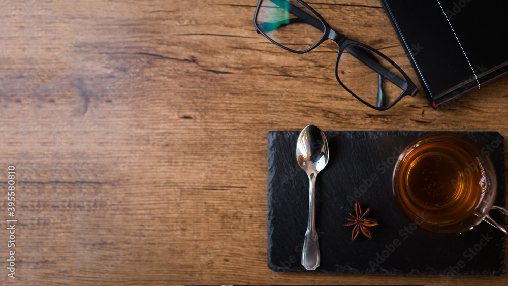 té, libro y lentes con fondo de madera, concepto trabajar desde casa té, libro y lentes con fondo de madera, concepto trabajar desde casa