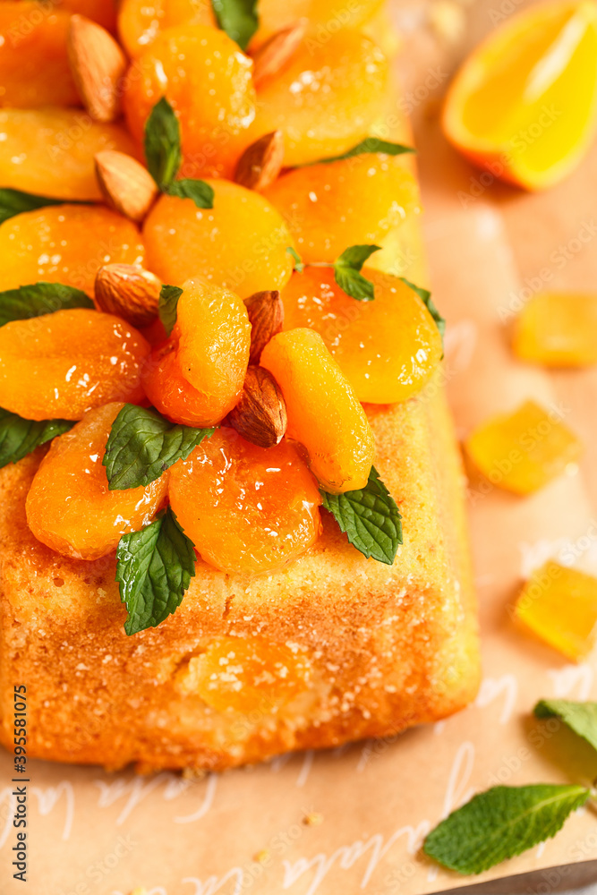 Orange Pound Cake flavored with freshly squeezed orange juice and zest decorated with dried apricots, mint and almonds.
