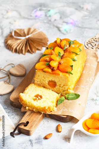 Orange Pound Cake flavored with freshly squeezed orange juice and zest decorated with dried apricots, mint and almonds.