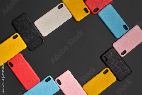 Foto Set of colorful protective smartphone cases or covers on black studio background