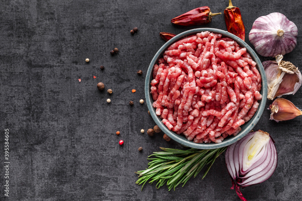 Shooting for the catalog.Mince. Ground meat with ingredients for cooking on black background. Minced beef. Top view.