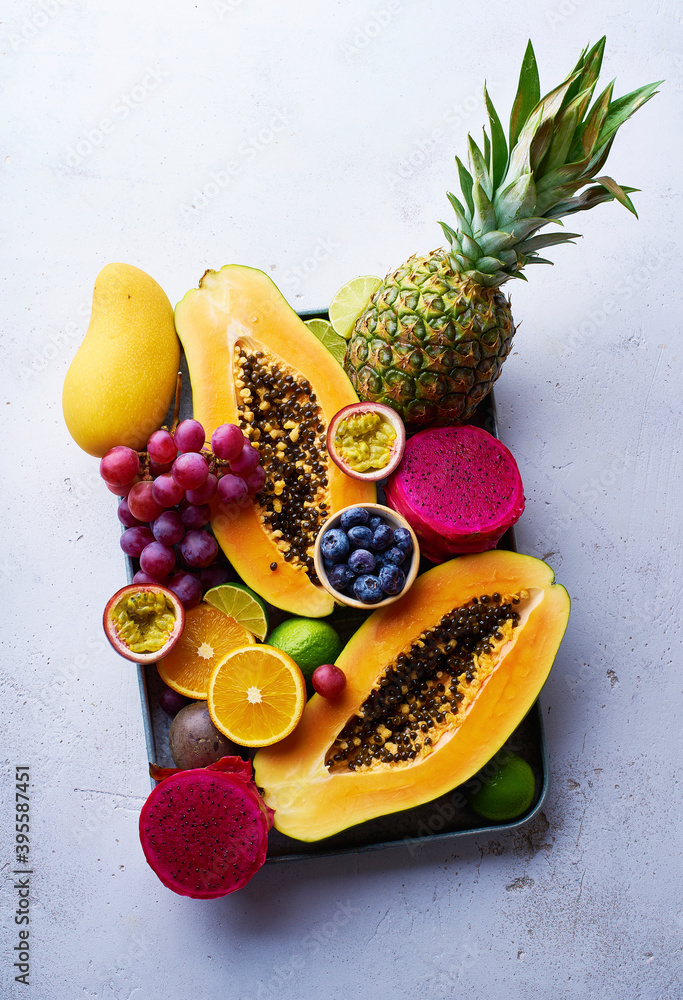Tropical fruits flat lay with mango, papaya, pitahaya, passion fruit
