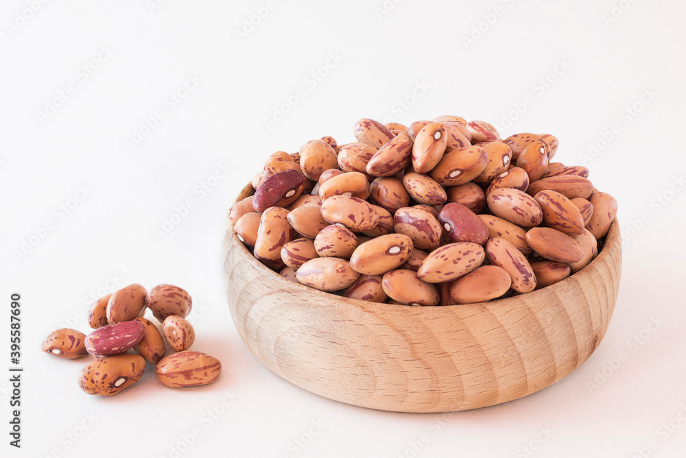 Dried borlotti beans in a wooden bowl Dried borlotti beans in a wooden bowl