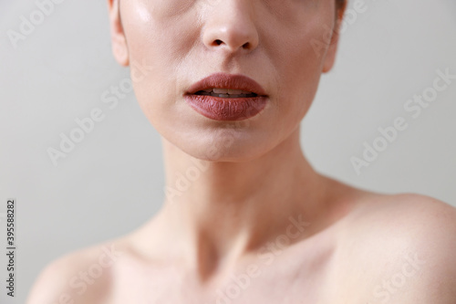 Studio beauty portrait of a young  healthy  beautiful  fresh skinned caucasian woman on a grey background