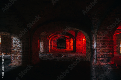 Dark and creepy vaulted red brick dungeon photo