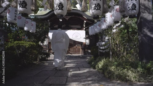 Japanese buddhist man walking in a temple in Osaka, Japan. photo