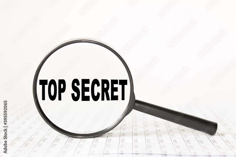 words TOP SECRET in a magnifying glass on a white background. business concept words TOP SECRET in a magnifying glass on a white background. business concept