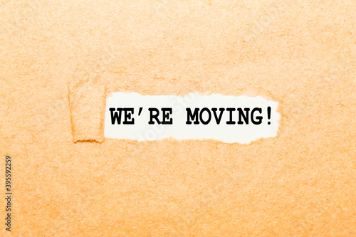 text WE'RE MOVING on a torn piece of paper, business concept