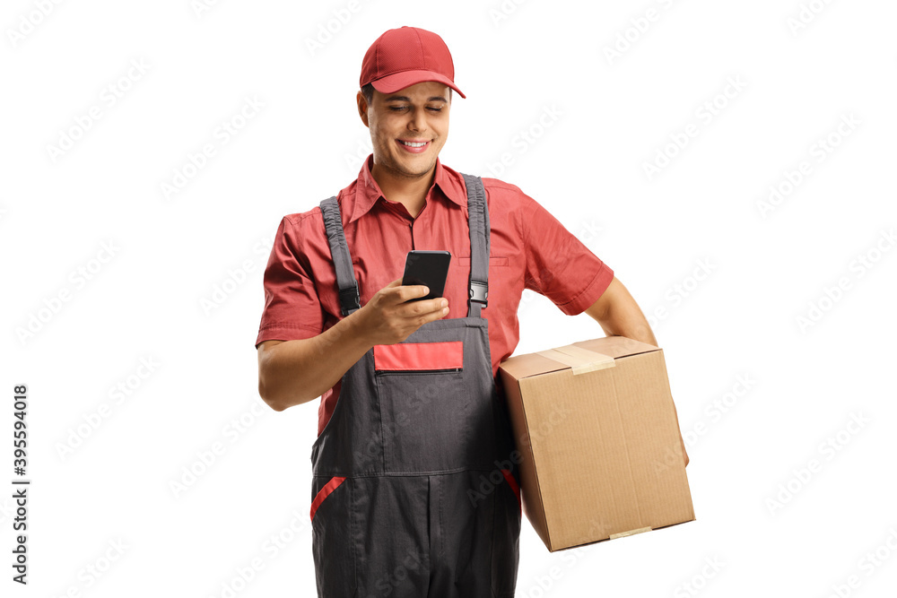 Male courier in a uniform holding a box and typing on a mobile phone Male courier in a uniform holding a box and typing on a mobile phone