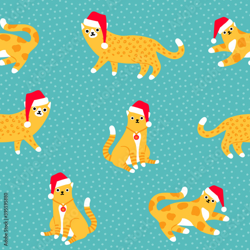 Christmas leopard and tiger cats in Santa s hats on pastel blue polka dot background seamless pattern.