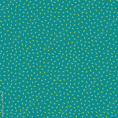 Christmas confetti sprinkles seamless pattern in teal, pastel blue, emerald and pistachio green.