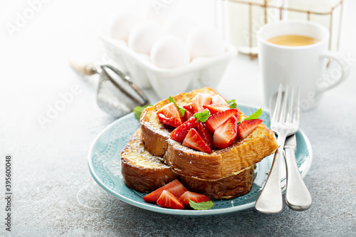 Spiked strawberry french toasts with powdered sugar photo