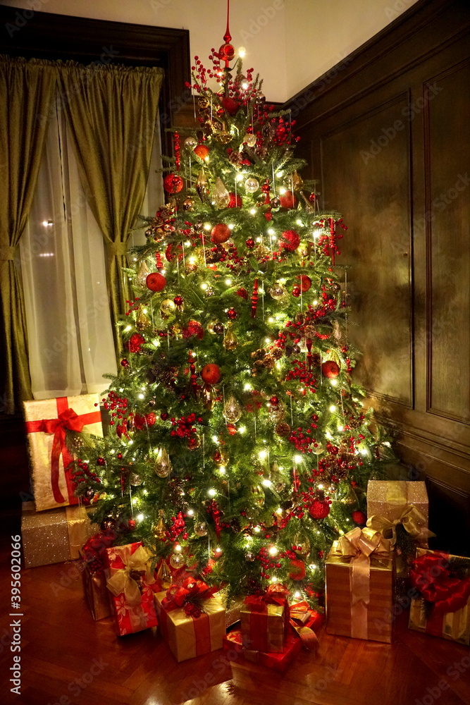 A beautiful Christmas tree decorated with lights and red ornaments