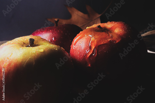 
Christmas background atmospheric photo of apples with honey on a dark background with lollipop