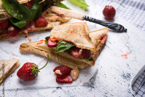 Vegan toasted sandwiches with strawberries, basil and vegan cheese photo