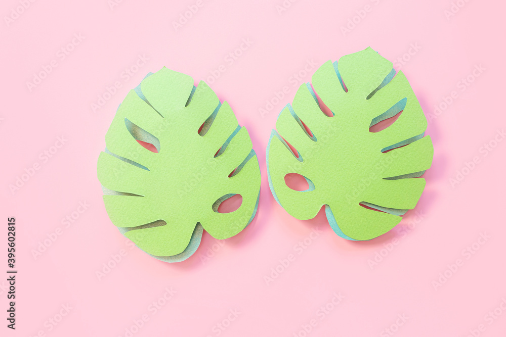 Paper monstera leaves on a pink background. Creative paper art. Background bright summer image. Paper monstera leaves on a pink background. Creative paper art. Background bright summer image.
