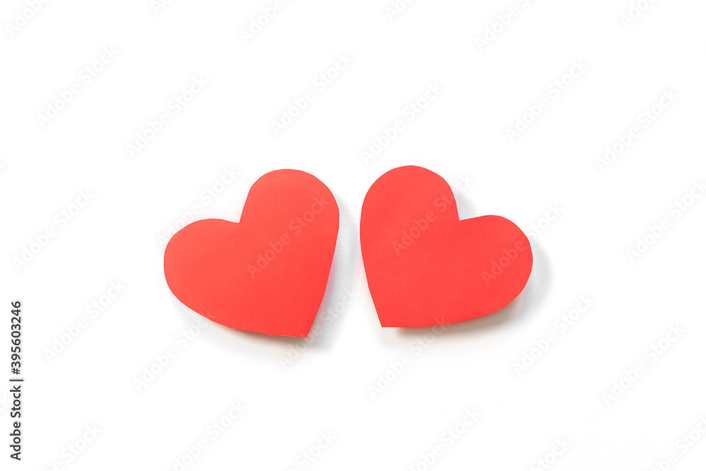 Two red paper hearts on a white background. Concept of romance, love, valentine's day. Minimalism, copy space, art paper. Two red paper hearts on a white background. Concept of romance, love, valentine's day. Minimalism, copy space, art paper.