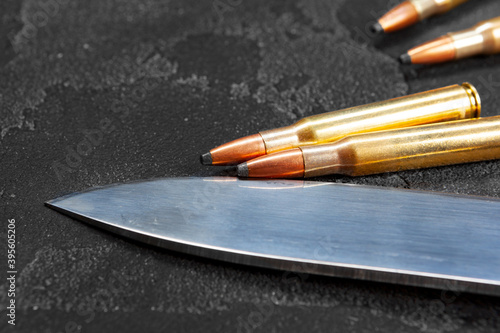 Cartridges for rifle or carbine on dark grey background close up