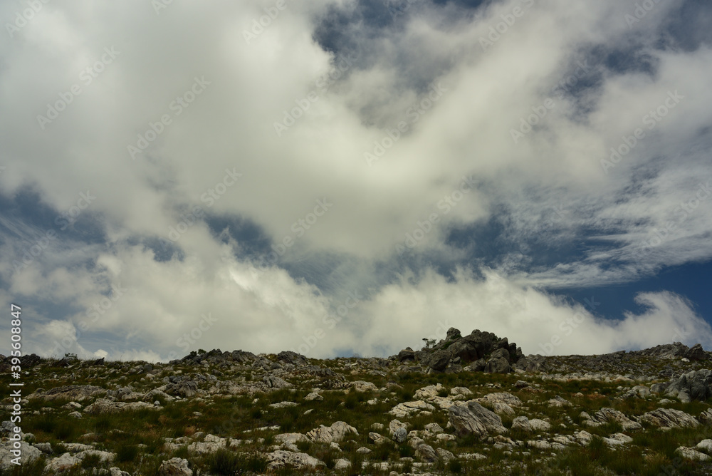 A composition of moon rocks against dramatic clouds
