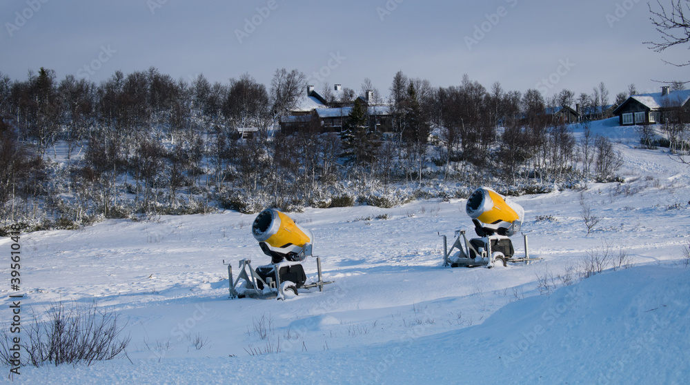 Snow Making Machine With Cabins in back ground. Snow Cannons