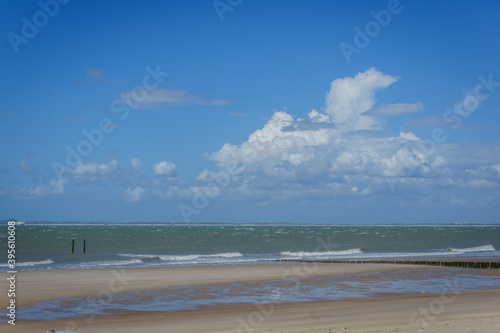 waves break on the beach of the north sea 