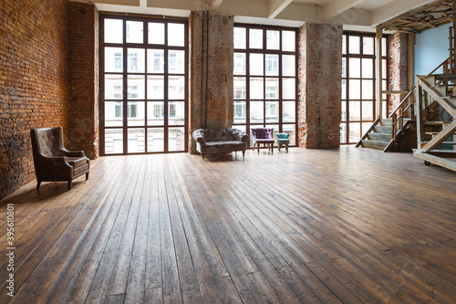 Interior design in loft style of spacious empty room with a huge windows