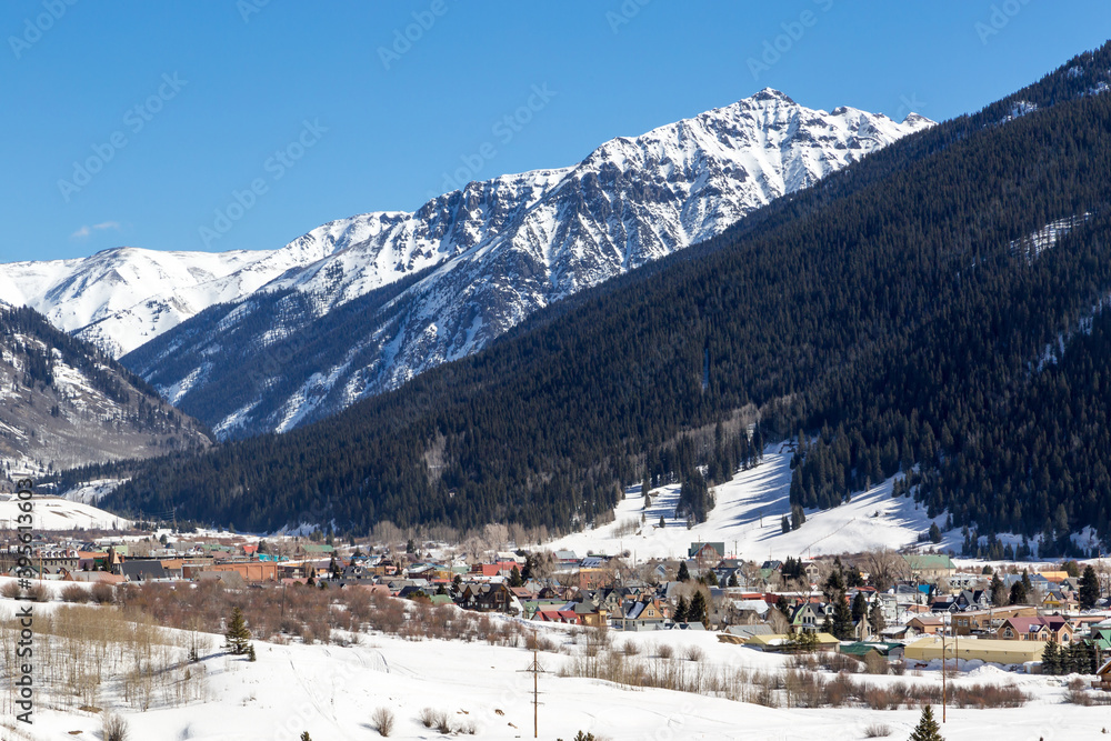 Mountains of Silverton - Overlook of Historic mining town of Silverton Colorado on a winter day with bright blue skies above the snowy mountain peak beyond the town
