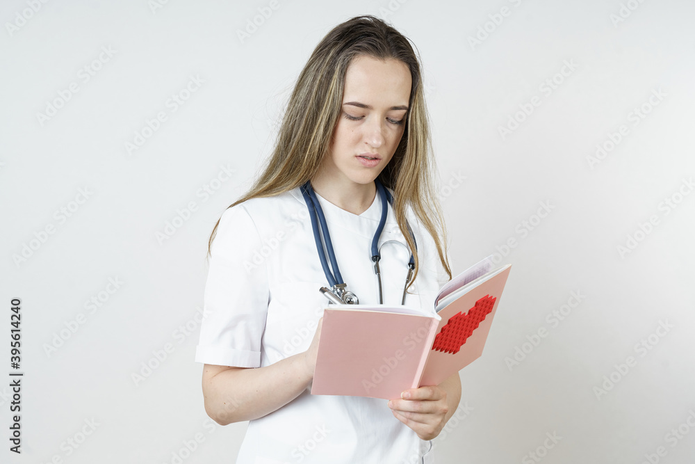 Medicine and health concept. Young female doctor writes in a notebook. Medicine and health concept. Young female doctor writes in a notebook.