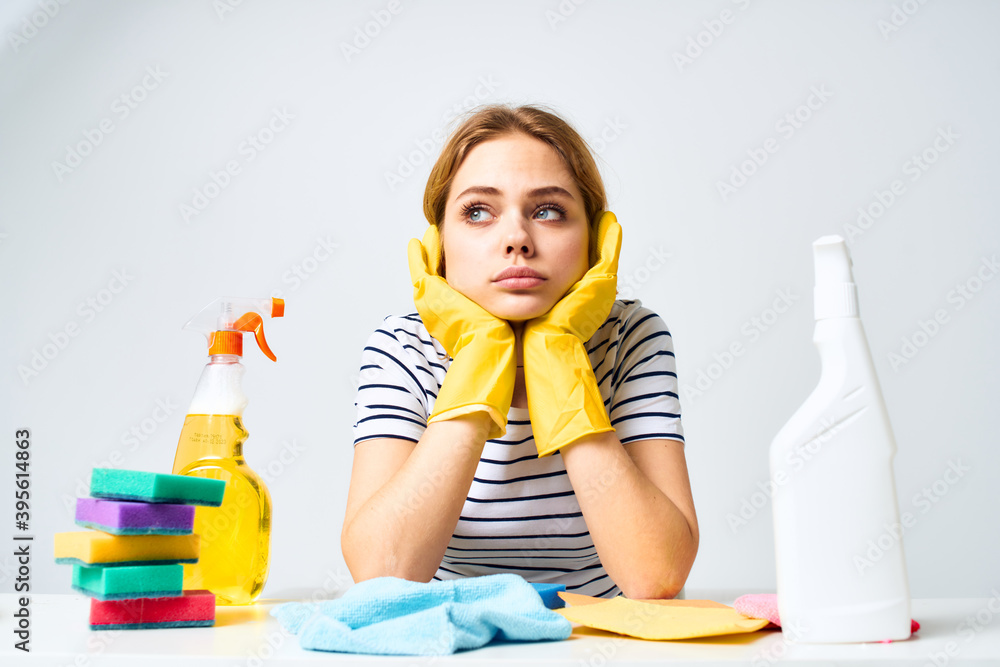 The cleaning lady sits at the table detergent work service The cleaning lady sits at the table detergent work service
