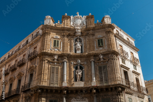 Front fasade of building with sculptures and columns in Palermo - Sicily, Italy.