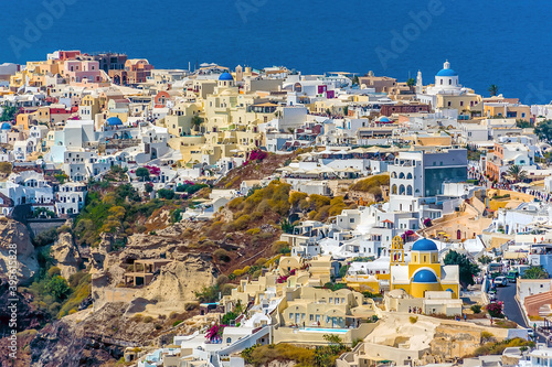 A view over the town of Oia from the Caldera rim path in Santorini in summertime