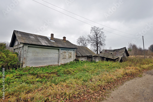 Ruined wooden farmhouse and barn. Abandoned village house. Concept: devastation, depression, decline of rural life © FedotovAnatoly