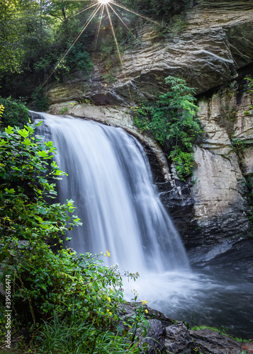 Morning sun twinkles above Looking glass falls in Pisgah Forest.