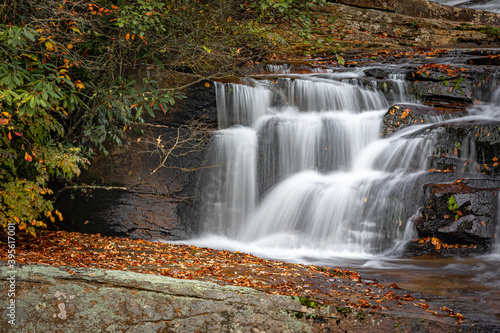 Portion of Carson Creek Falls surrounded by colorful leaves