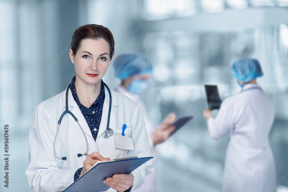 A woman doctor stands with a medical history . A woman doctor stands with a medical history .