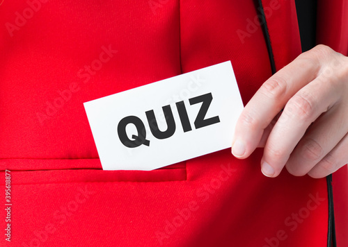 Businessman putting a card with text QUIZ in the pocket