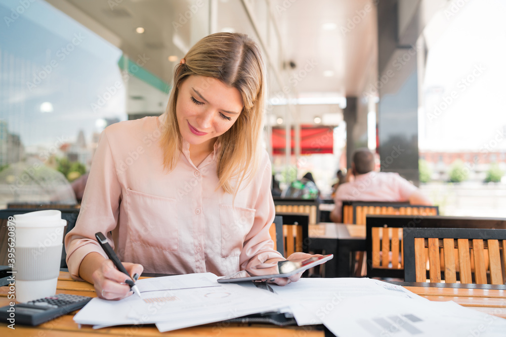 Young businesswoman working with a digital tablet. Young businesswoman working with a digital tablet.