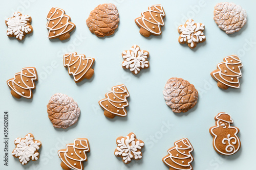 Christmas homemade gingerbread cookies on blue background. Xmas greeting card. View from above. Flat lay.