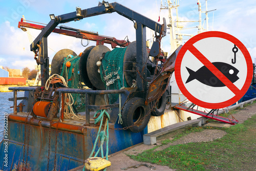 Seasonal ban on fishing at sea. Sign prohibiting fishing on the background of the seiner.