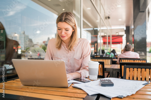 Young businesswoman working on her laptop. © Mego-studio