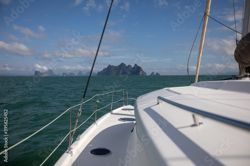 View of the blue sea water from the side of a sailboat with rigging and sails. Tackle barge, sail, masts, yards, deck, ropes,