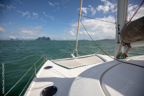 View of the blue sea water from the side of a sailboat with rigging and sails. Tackle barge, sail, masts, yards, deck, ropes,
