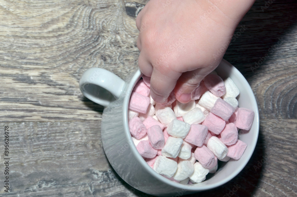 with colorful marshmallows on wooden silver background. with colorful marshmallows on wooden silver background.