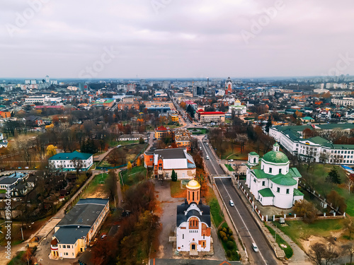 Aerial view of roundabout road with circular cars in small european city at autumn cloudy day