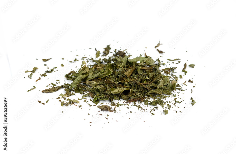 Dried mint herb isolated on white background. A handful of dried mint leaves. Dried mint herb isolated on white background. A handful of dried mint leaves.