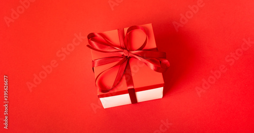 Gift box with a cones on a red background. Christmas background. Top view. Space for text.