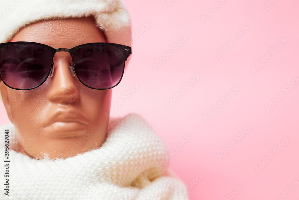 mannequin with glasses and a scarf, discounts on winter clothes and accessories, on a pink background, banner, copy space